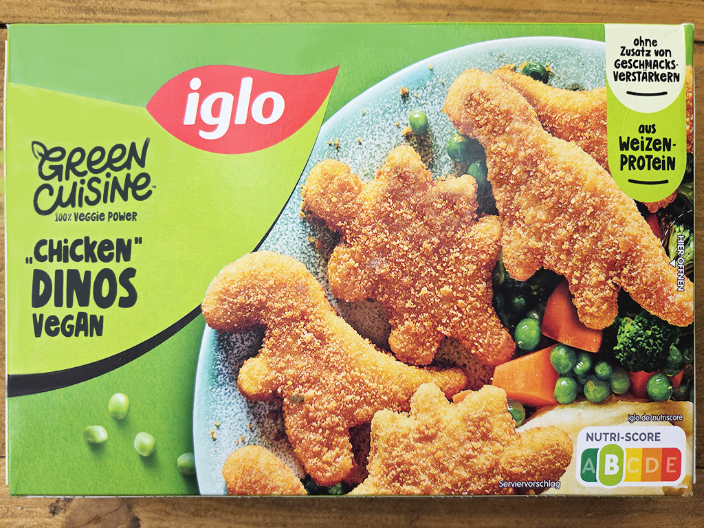 Pack of Iglo Green Cuisine Chicken Dinos Vegan nuggets with mixed vegetables on a plate, green branding visible on the box
