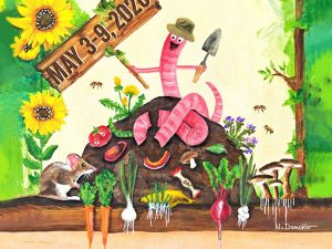 Whimsical worm with a hat on a dirt mound, holding a shovel, among sunflowers and vegetables with a 'May 3-9, 2016' banner.