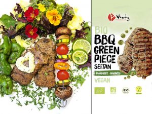 Vegan BBQ dish with grilled seitan pieces, vegetables, and greens on a white plate next to vegan seitan packaging labeled BBQ Green Piece Seitan (Wheaty).
