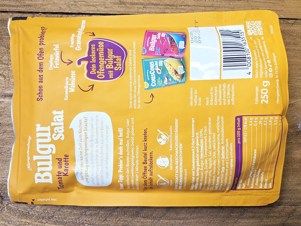 Hengstenberg | Bulgur Salat mit Tomate und Karotte | Herzschatz Bright yellow bag of salad mix packaging with a barcode and nutrition panel on the right, 250 g shown.