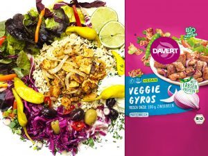 A vibrant vegan lunch plate with rice, greens, olives, peppers, and crispy pieces, next to a pink Veggie Gyros package on the right.