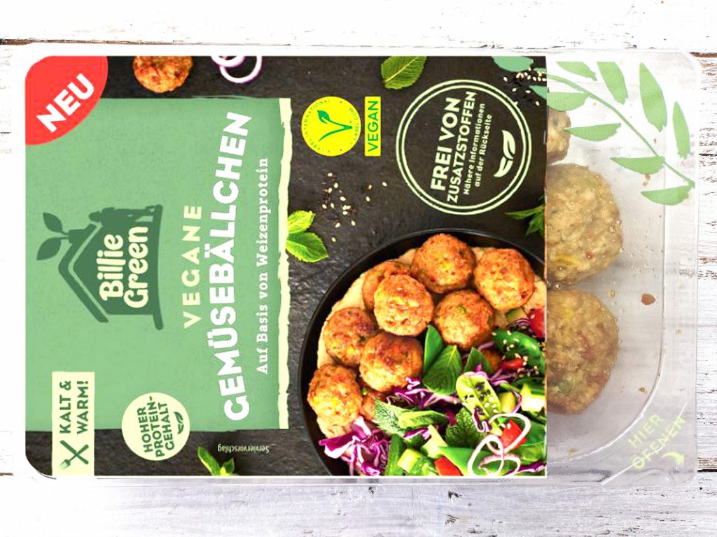 Green vegan falafel mix packaging shown with a plate of fried falafel and salad on the side.