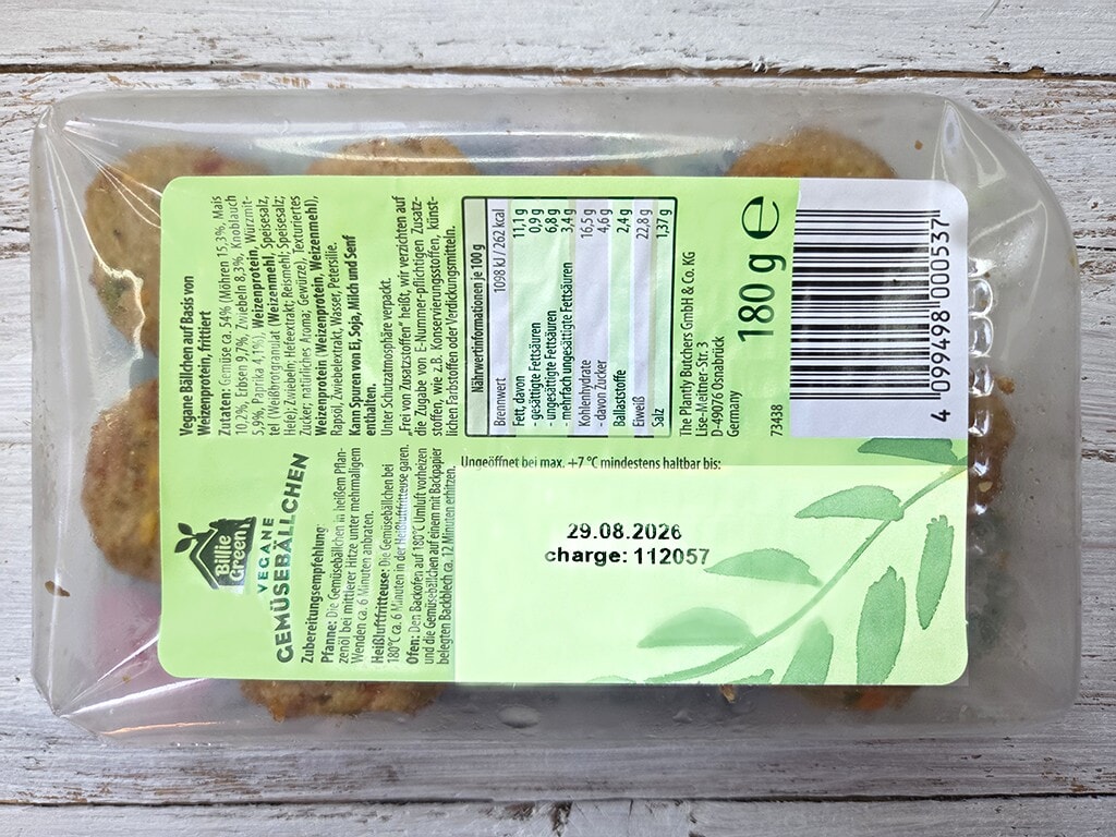 Transparent plastic package containing several round baked cookies with a light green label featuring nutrition text, a barcode, and an 180 g weight indication.
