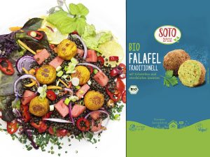 Colorful Mediterranean salad with falafel balls on a white plate beside a blue Falafel packaging label (SOTO BIO). May convey vegan meal idea.